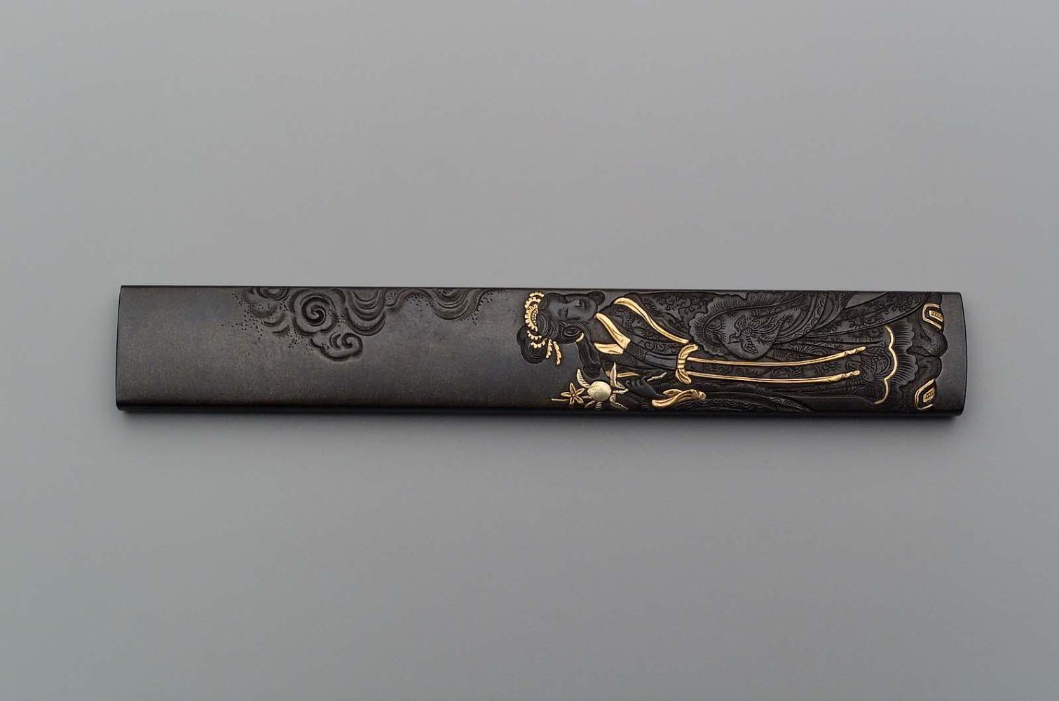 Kozuka with design of Seiobo holding a peach