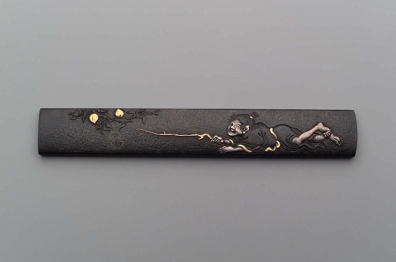Kozuka with design of boy stealing peaches from a tree