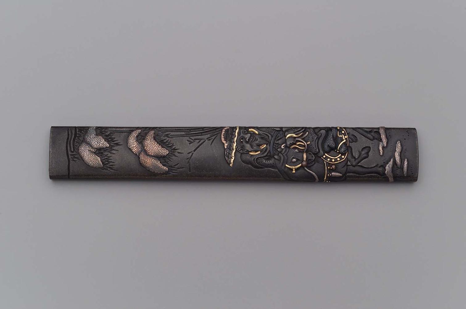 Kozuka with design of Toba riding into exile beneath snow-laden bamboo