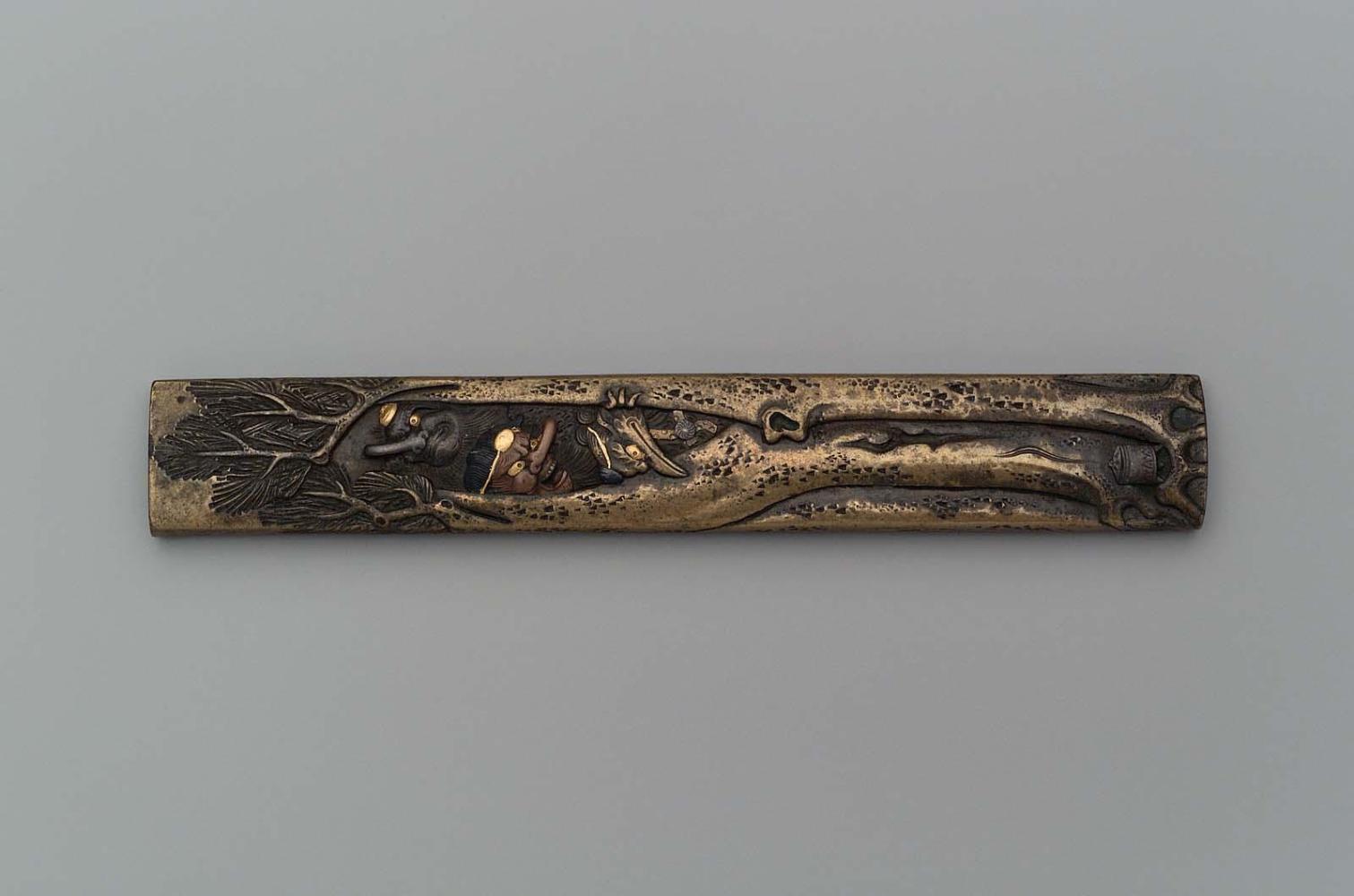 Kozuka with design of tengu in a pine tree