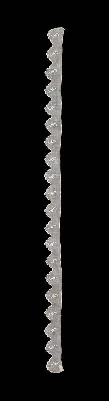 Part of a narrow ruffle of sprigged mull