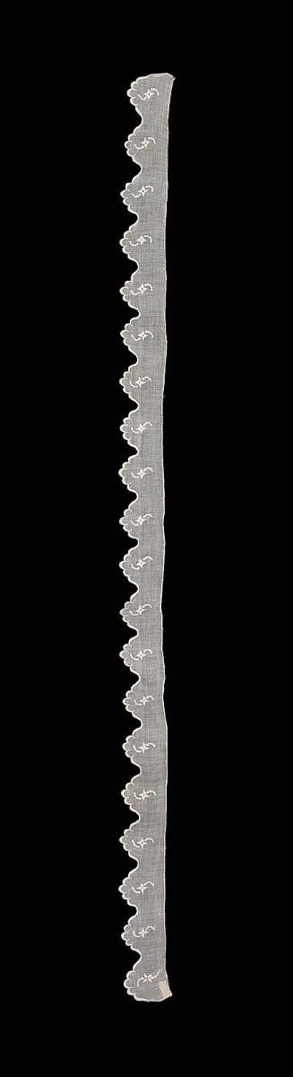 Part of a narrow ruffle of sprigged mull