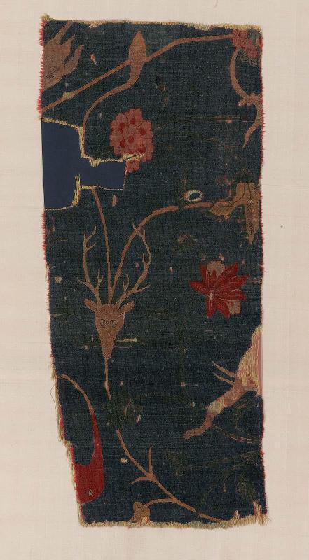 Fragment of a carpet with scrolling vines and animal heads