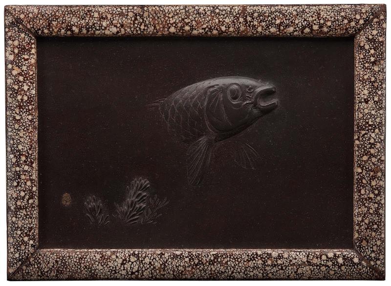 Plaque depicting a carp emerging from the water