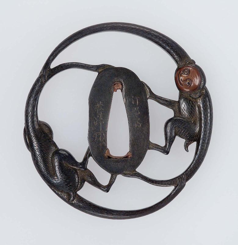 Tsuba in the form of two long-armed monkeys arranged around the seppadai