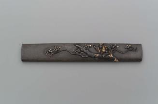 Kozuka with design of a man with a basket sitting in a cherry tree