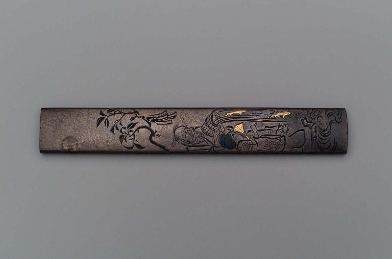 Kozuka with design of a man pouring fish from a bucket watched by a boy
