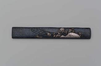 Kozuka with design of Hotei in a boat with two Chinese boys