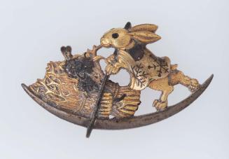 Menuki in the form of a hare poling a moon-shaped boat filled with flowers and bundles of firewood