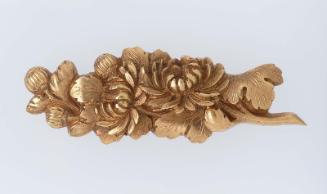 Menuki in the form of a branch of chrysanthemum