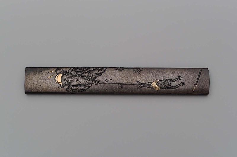 Kozuka with design of Shoki lowering an oni down a cliff to recover his sword