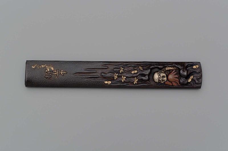 Kozuka with design of Daruma seated in a grotto