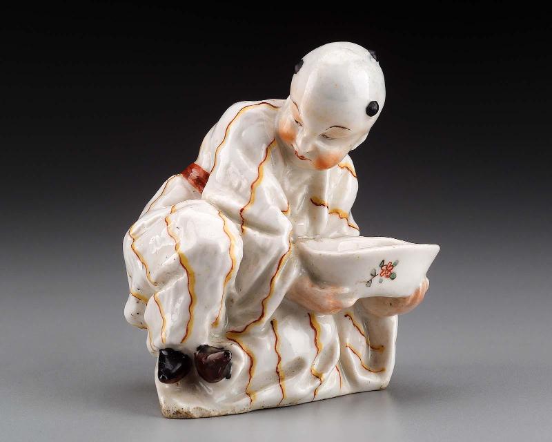 Figure of a Chinese boy with a cup