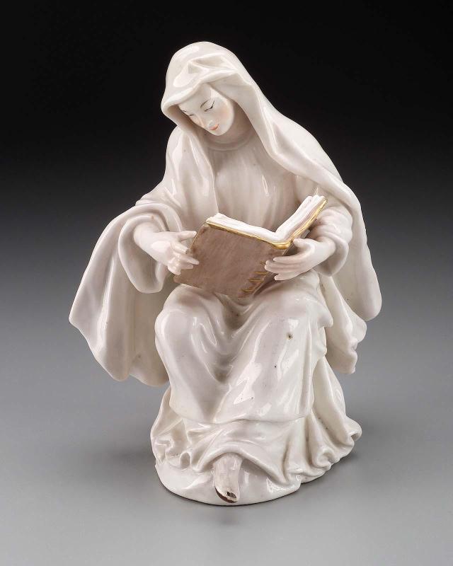 Figure of a young Nun seated