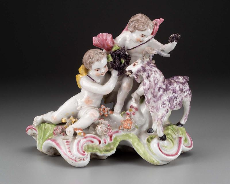 Two putti and a goat with grapes