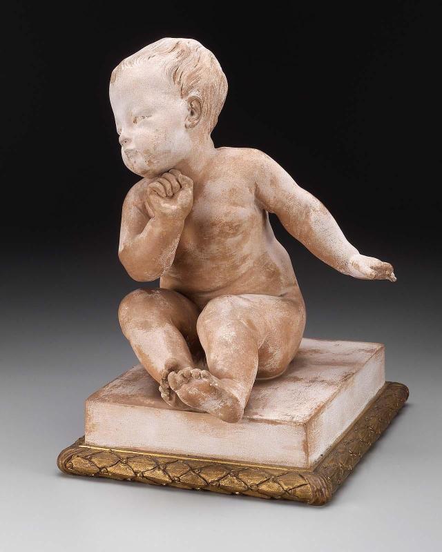 Bisque nude figure of a seated child