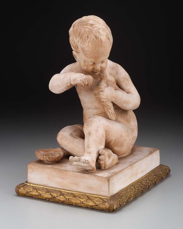 Bisque nude figure of a seated child