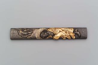 Kozuka with design of Daruma standing beneath a crag