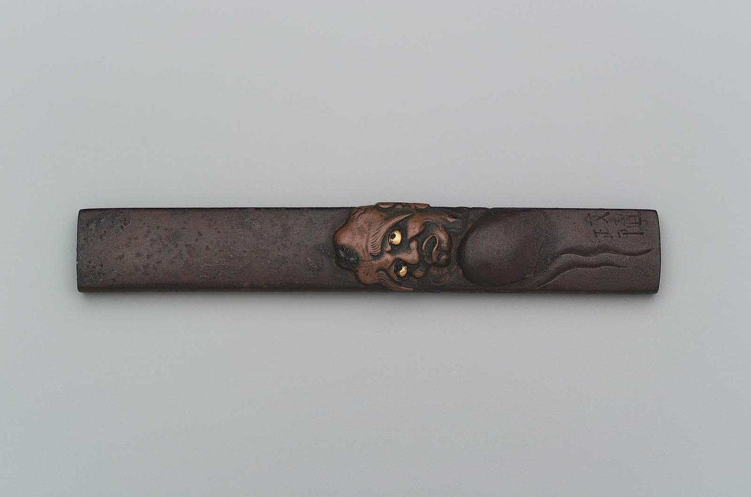 Kozuka with design of Daruma irritated by an insect on his head