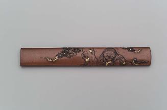 Kozuka with design of boy with scroll seated beneath a tree