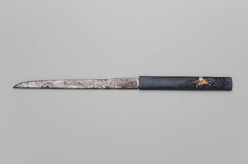 Kozuka with design of boar running through the waves with a mirror on its back