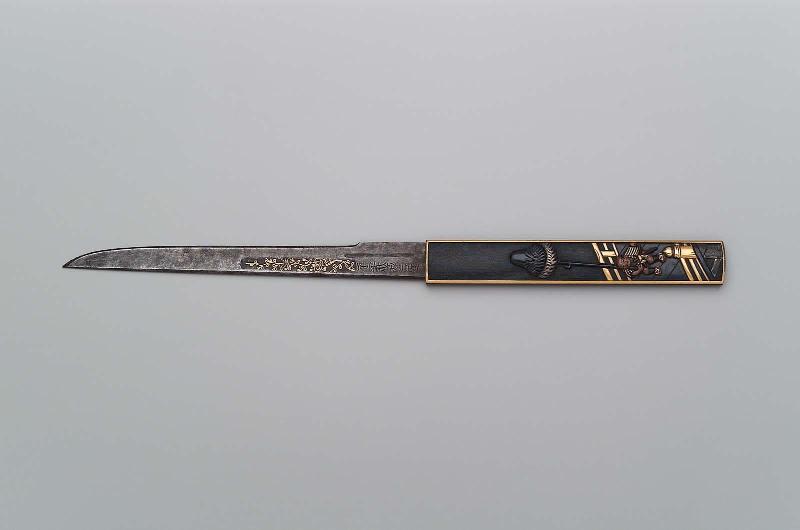Kozuka with design of samurai attendant with a banner crossing a bridge