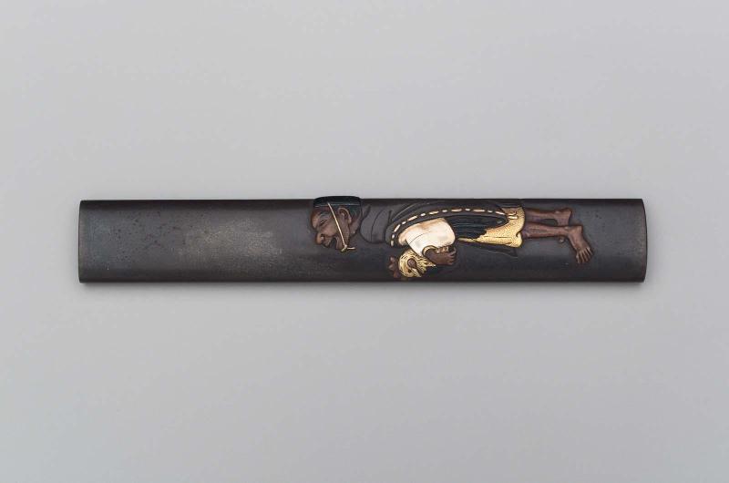 Kozuka with design of figure holding a cockerel under his arm