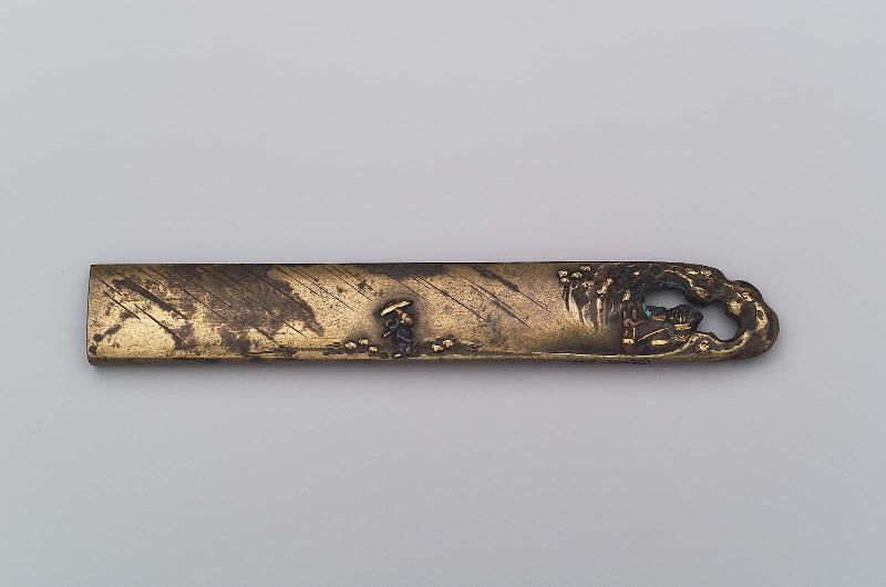 Kozuka with design of figure of a horse passing through an opening in the kozuka