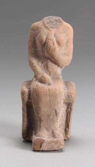 Figurine of seated female holding a flower