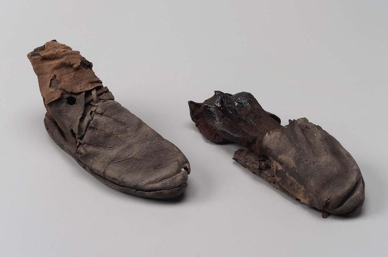 Leather shoe with mummified foot remains