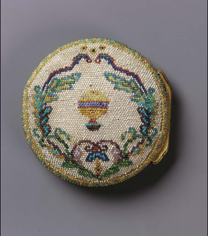 Two watch cases and a perfume bottle