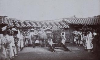 Hat shop in the main street, Seoul: Hats judiciously exposed to view on the roof and in the street (NRICP Relic No.: 2921)