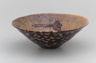 Tea bowl with design of flower and bird in mottled black and brown glazes