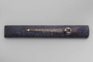 Kozuka with design of Okame mask on hanger