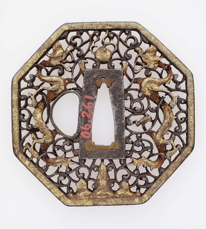 Tsuba with design of confronted dragons, jewel and stylized mountain, within floral scrolls