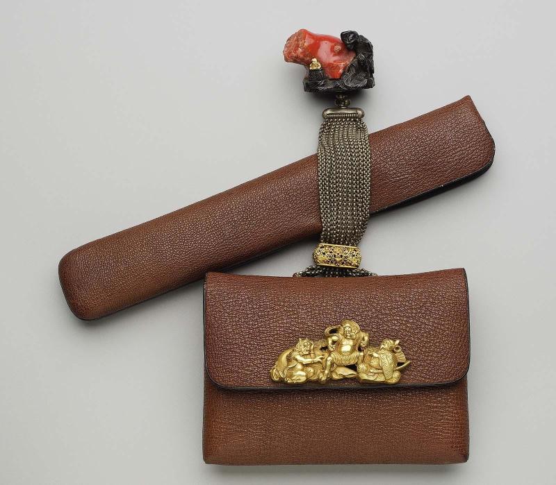 Tobacco-pouch and pipecase; netsuke in the form of a koronbo with a giant piece of coral; kanamono in the form of a seated samurai and two oni; rectangular gold filigree ojime; silver chains