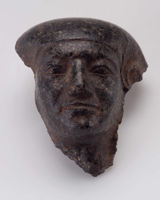 Head fragment from a male granite statue