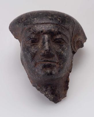 Head fragment from a male granite statue