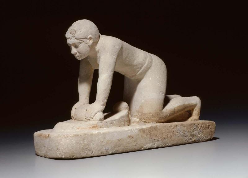 Serving statuette of a woman grinding grain