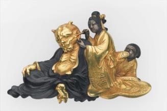 Kanamono in the form of a courtesan cleaning an oni's ears, with a young boy in attendance