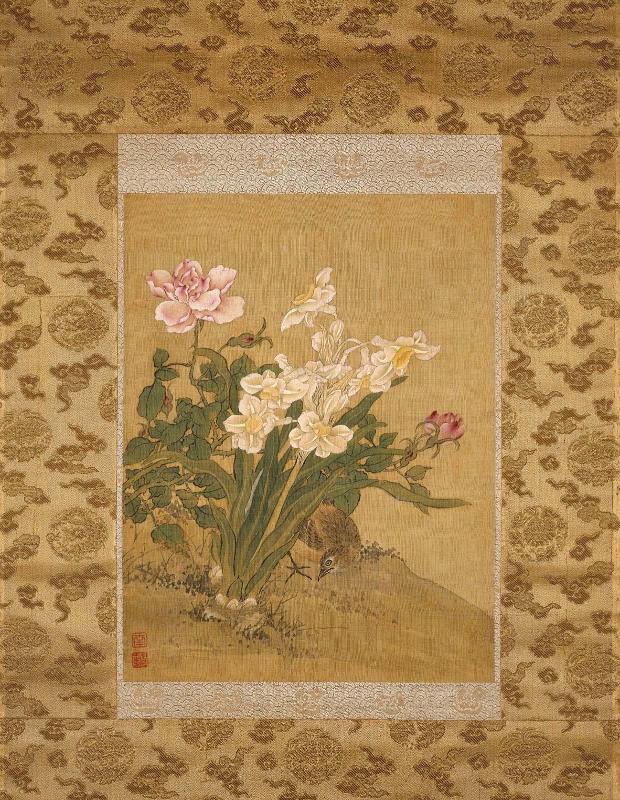 Bird beneath a narcissus plant and blossoming rose bush