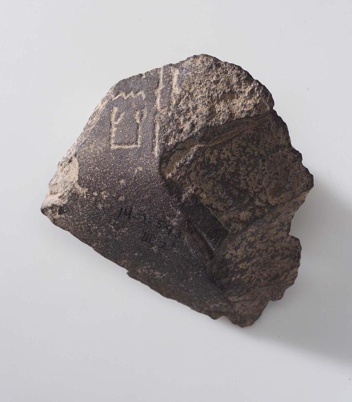 Inscribed fragment of a cross-legged(?) figure