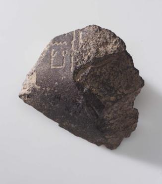 Inscribed fragment of a cross-legged(?) figure