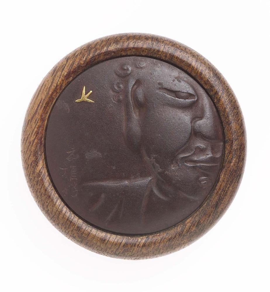 Kagami netsuke with design of Great Buddha (Daibutsu) figure and swallow