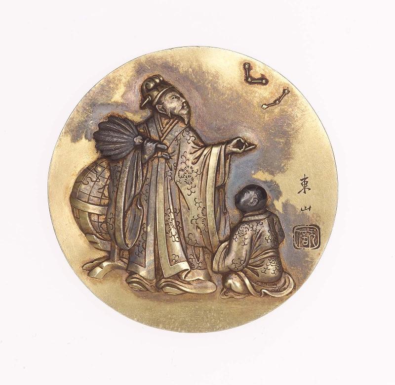 Kagami netsuke plate with design of Zhuge Liang and an attendant with globe and constellations