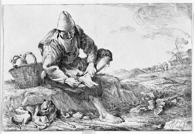 Boy extracting a thorn from his foot