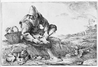 Boy extracting a thorn from his foot