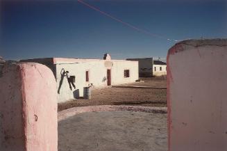 Boquillas, Coahuila, Mexico (Man jumping against wall)