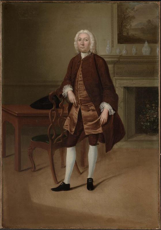 Portrait of a Man Standing Beside a Table