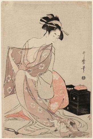 Woman Sewing and Playful Kitten